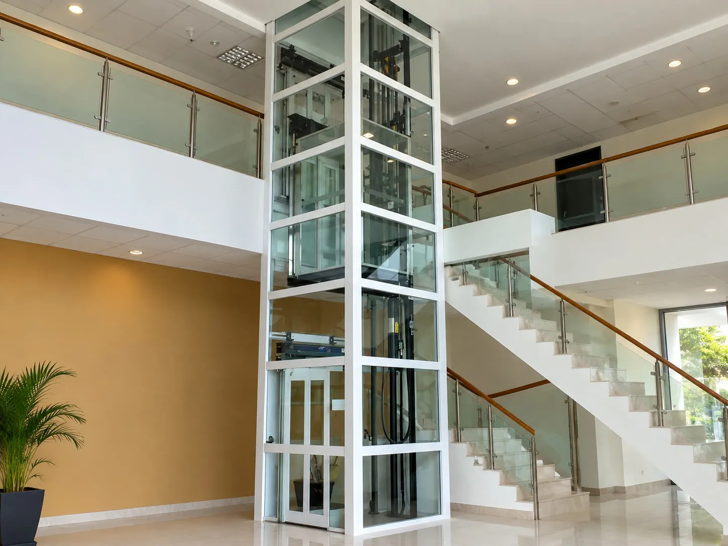 Indoor home lift shaft integrated beside a staircase