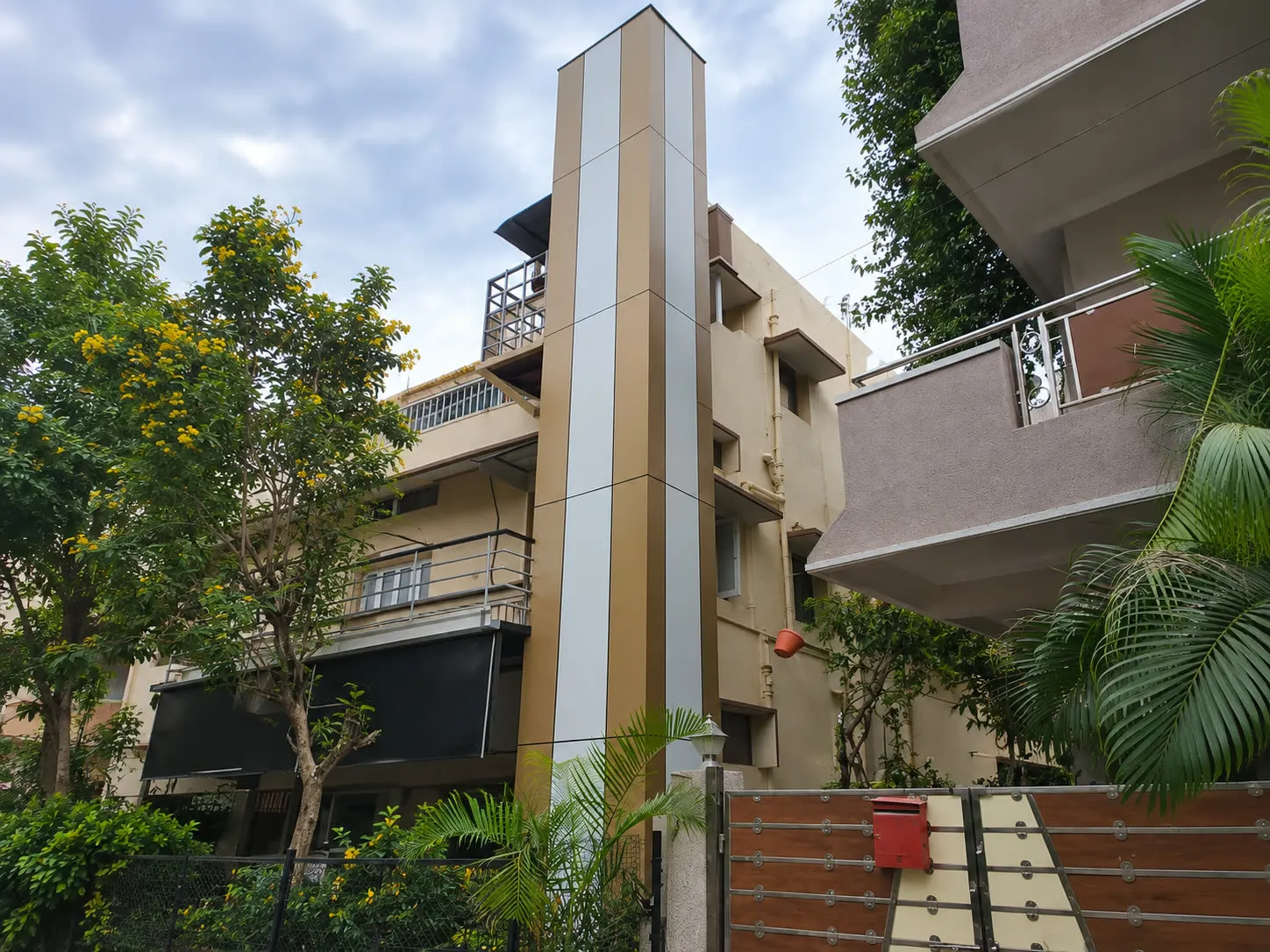 Outdoor home lift shaft installed alongside a residence