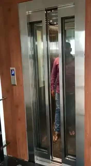 Home lift with wood-panel surround installed by Oriental Lift